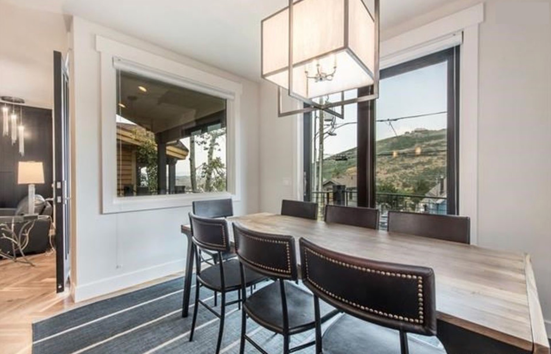 Dining room with mountain view and pendant lantern