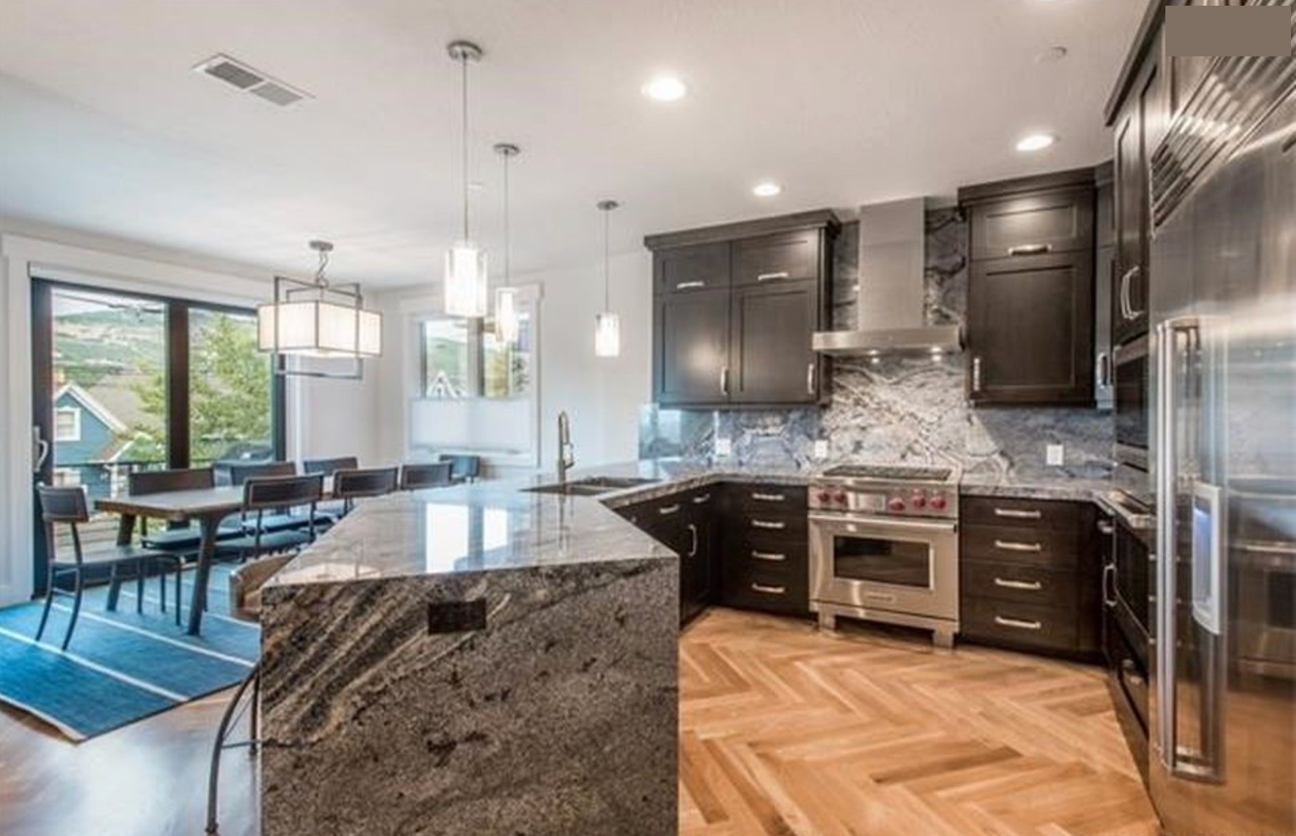 Chef's kitchen — granite island, Wolf range, herringbone walnut floor