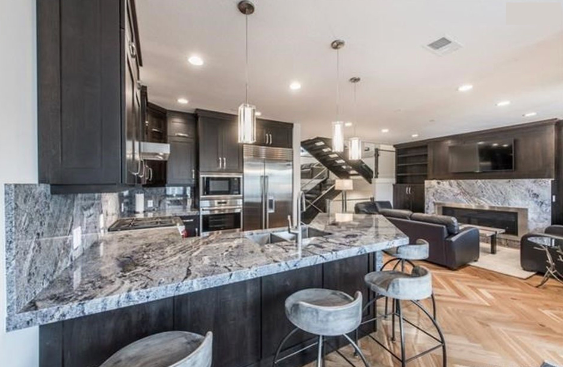Kitchen looking through to the family room and floating staircase