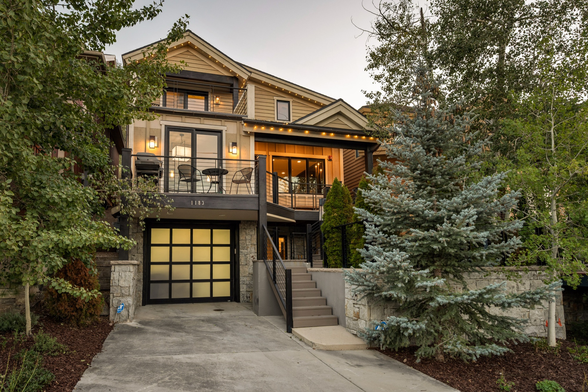 Old Town Estate exterior — the front porch, balcony, and stone-walled entry