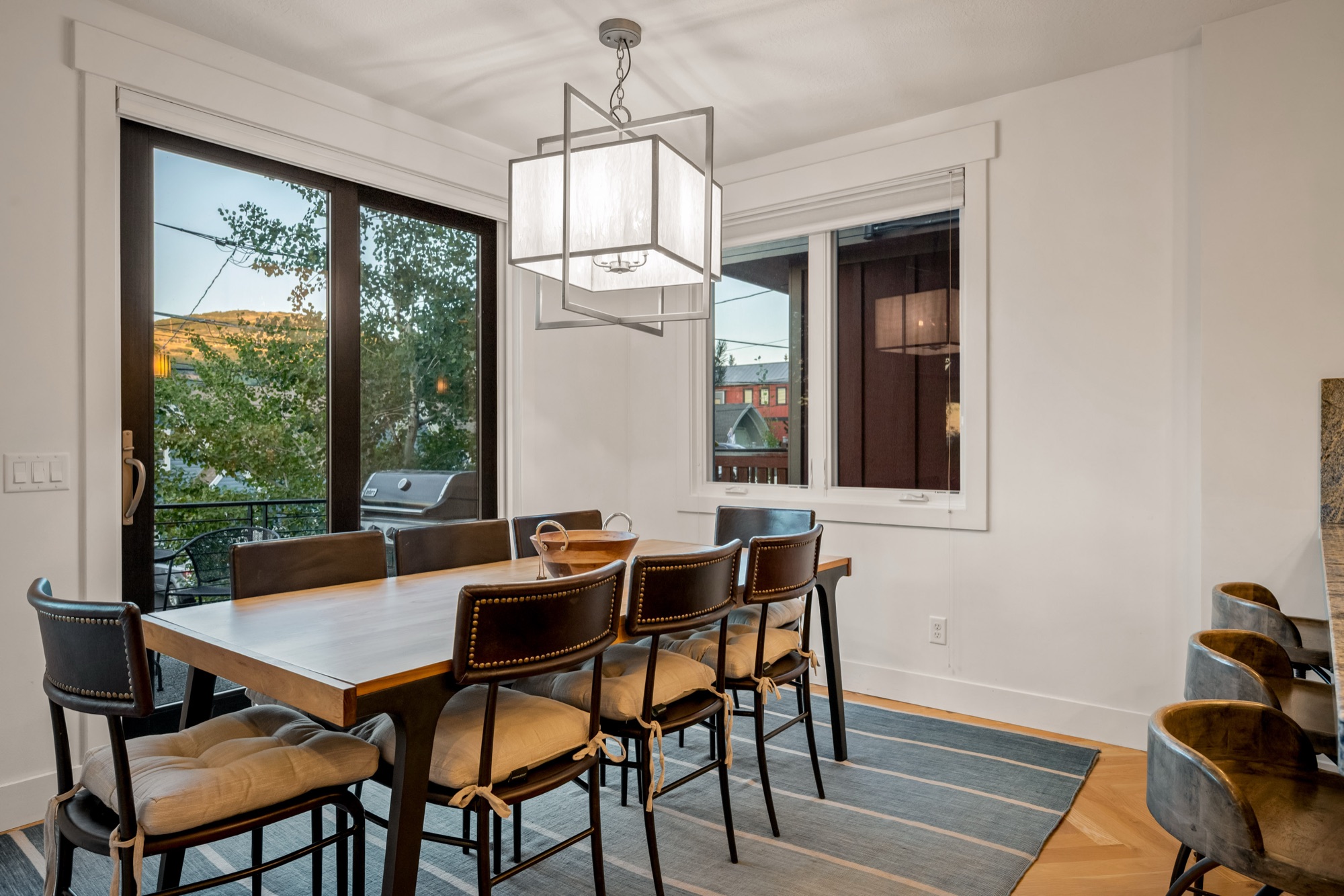Dining room with mountain view and pendant lantern