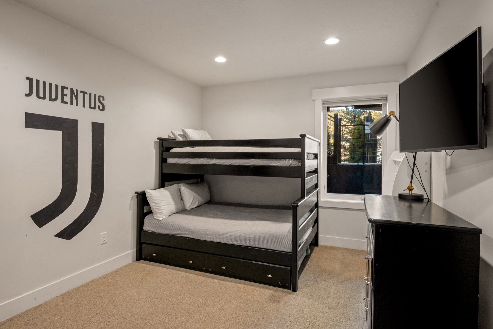 Bunk room — twin-over-full bunk plus trundle, sleeps four